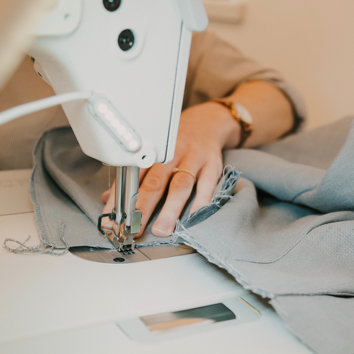 Woman's hands at sewing machine