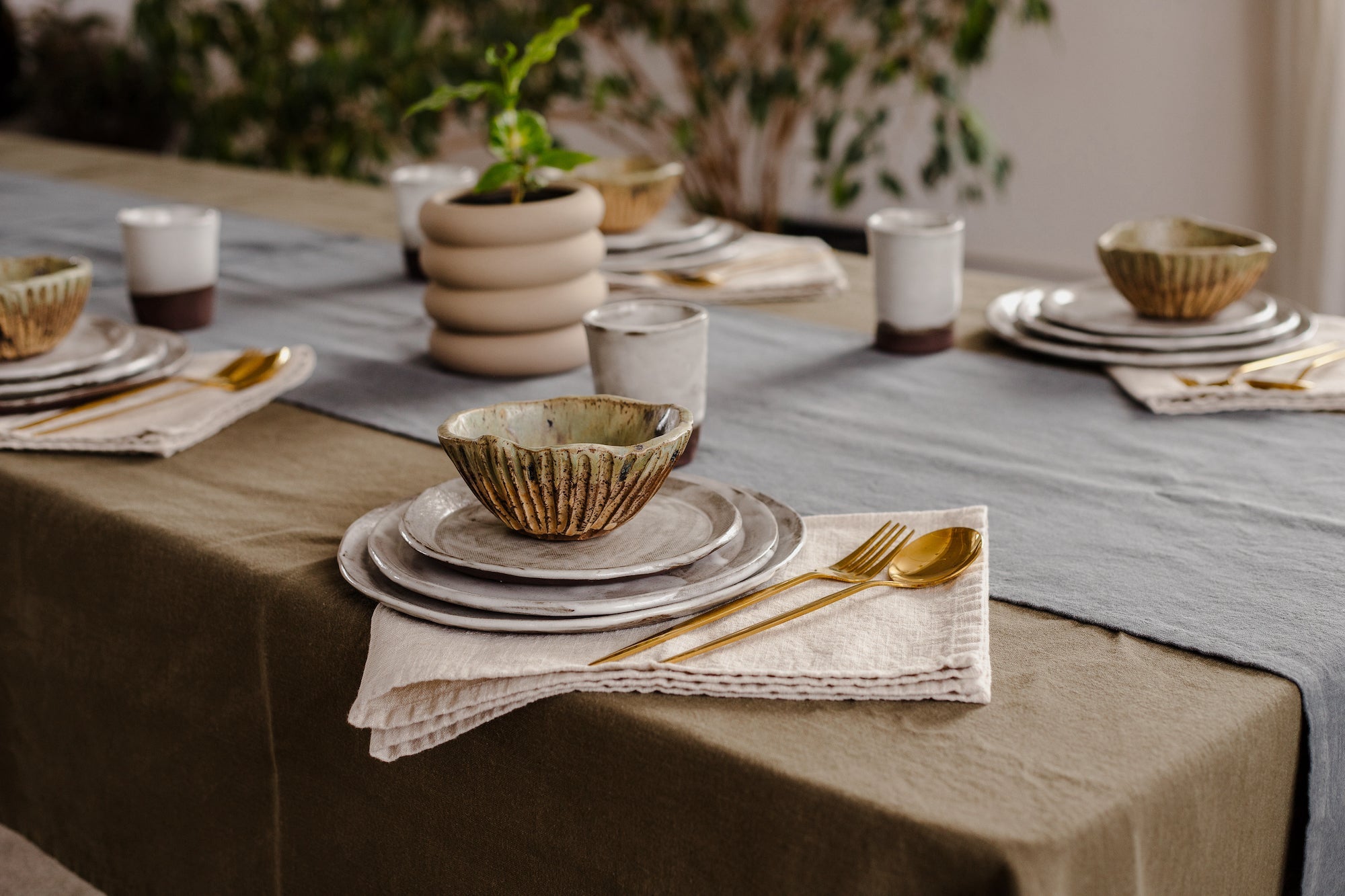 Table setting with linen tablecloth, runner, and napkins