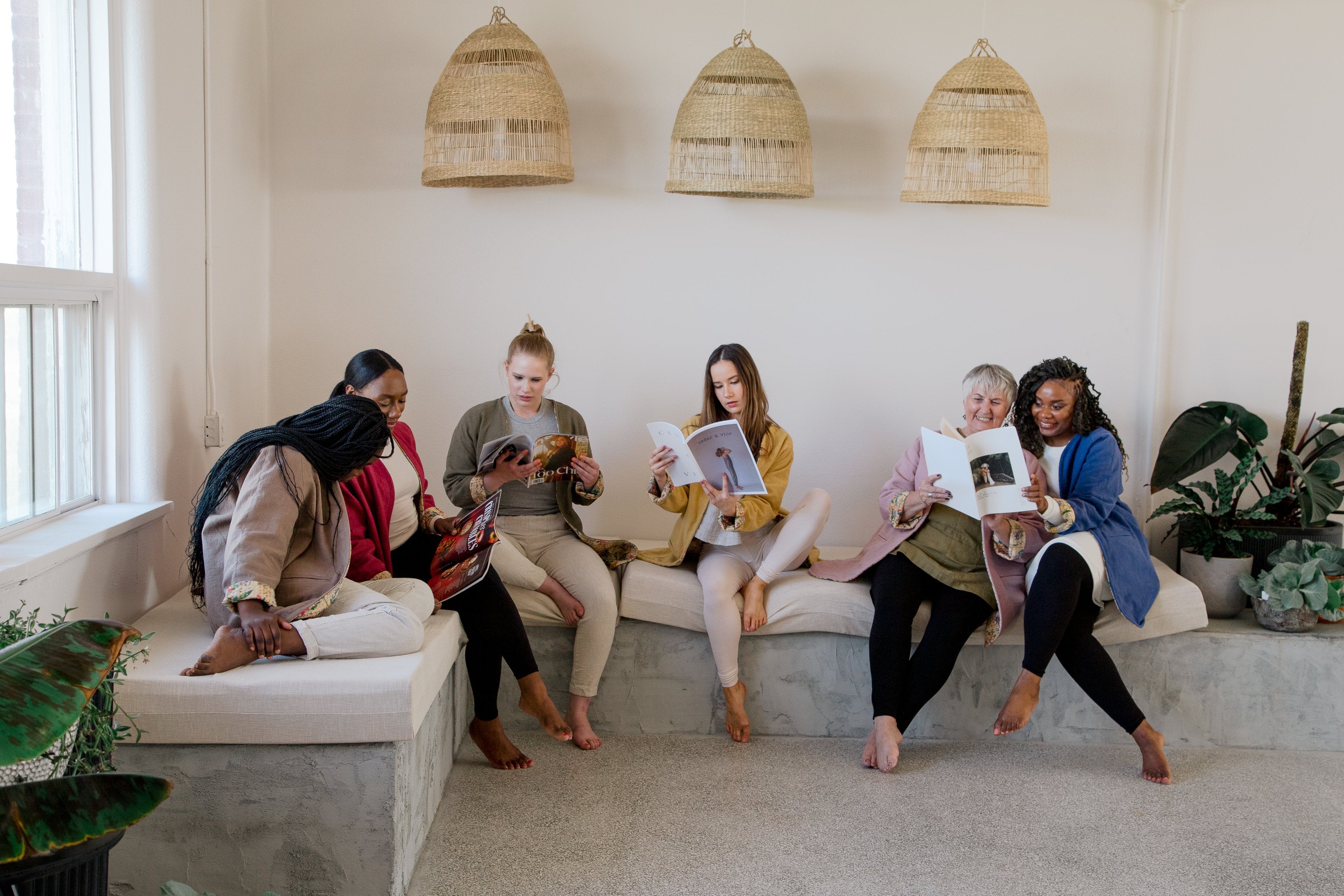 Linen clothing and models sitting on couch